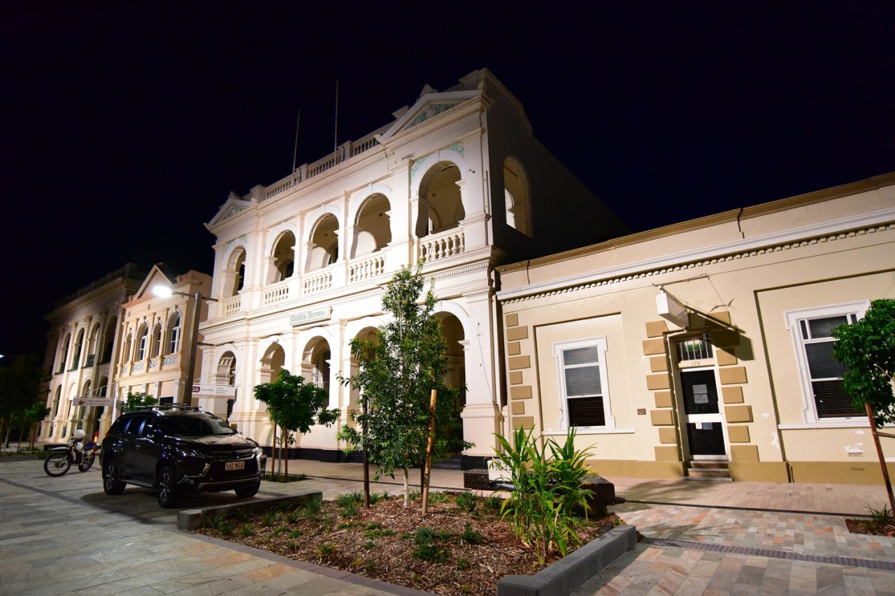 White lighting highlights the heritage facade and arches in Rockhampton's riverside precinct.