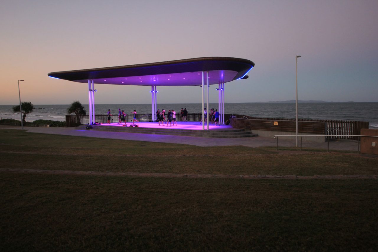 Purple lighting beneath the Yeppoon beachfront amphitheatre roof at dusk.