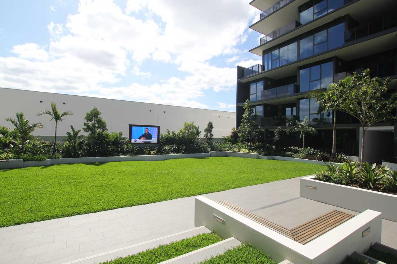Wide view across the Newstead North lawn towards the outdoor screen.