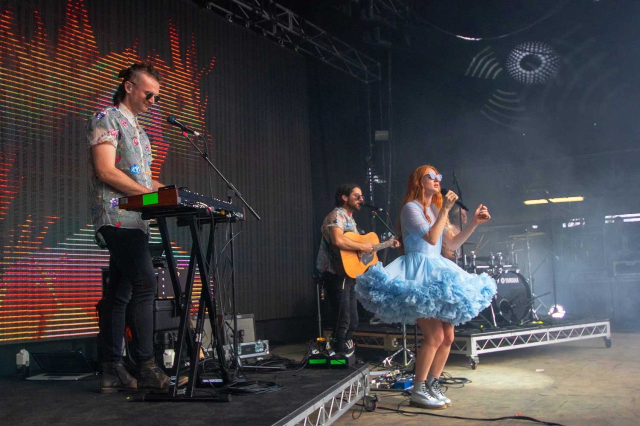 Singer in a blue dress performing beside a keyboard player at Spilt Milk 2018.