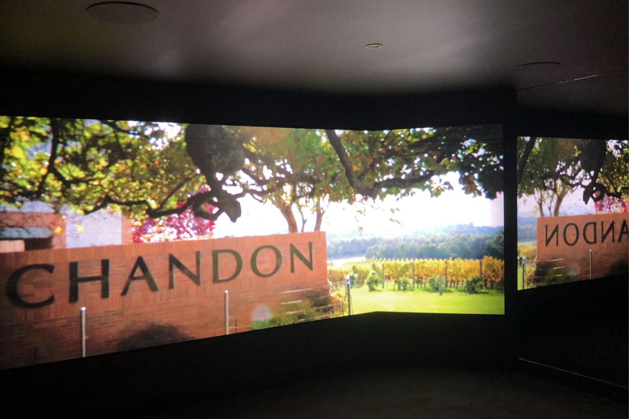 Vineyard and Chandon signage imagery across the exhibit video wall.