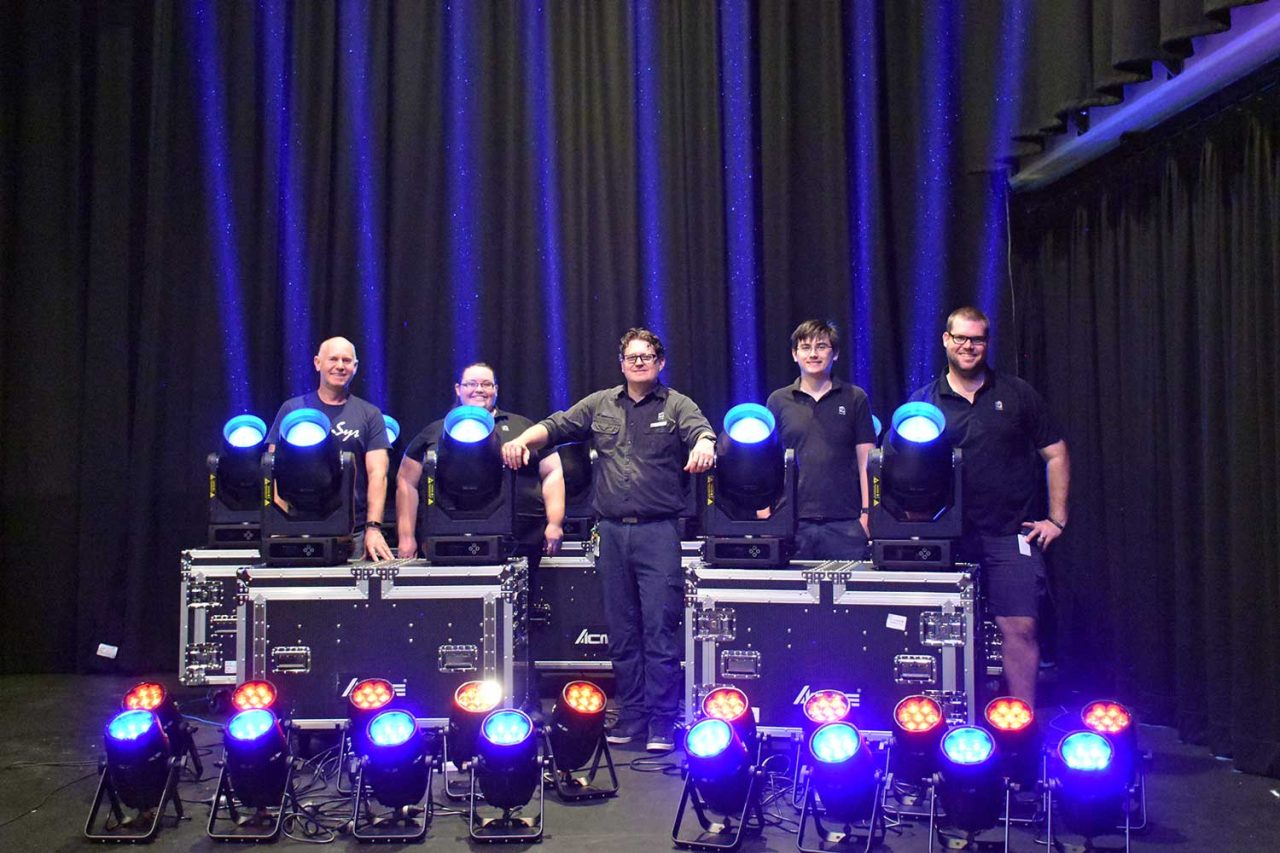 Theatre team behind rows of new lighting fixtures at Townsville Civic Theatre.