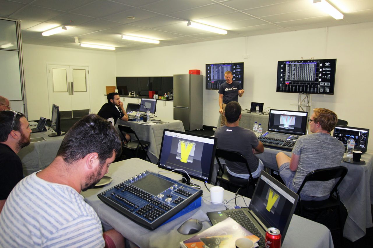 Participants practising at consoles during a ChamSys training class.