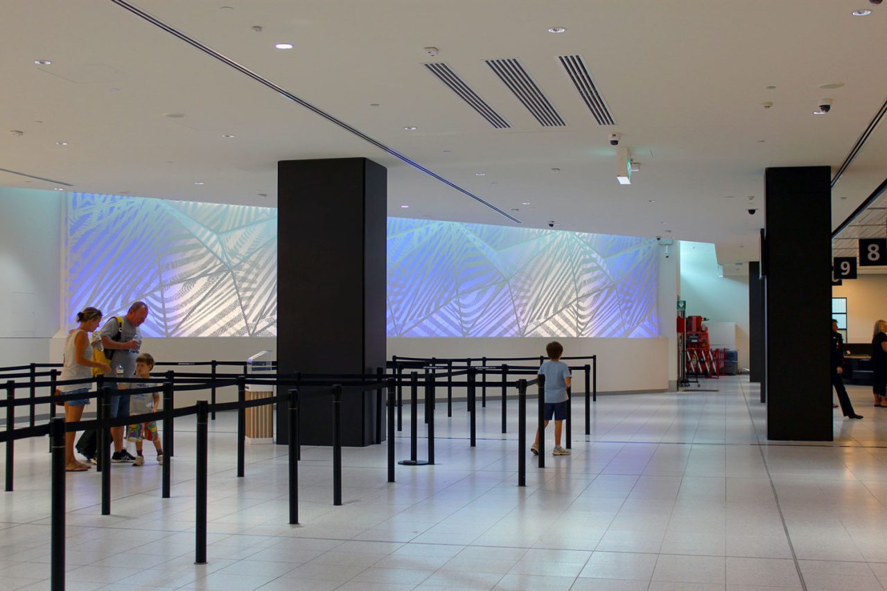 Wide view of Traverse across a terminal wall with queue barriers in front.