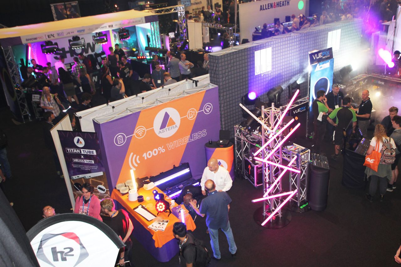 Elevated view of ULA's busy ENTECH stand with LED tubes and lighting demonstrations.