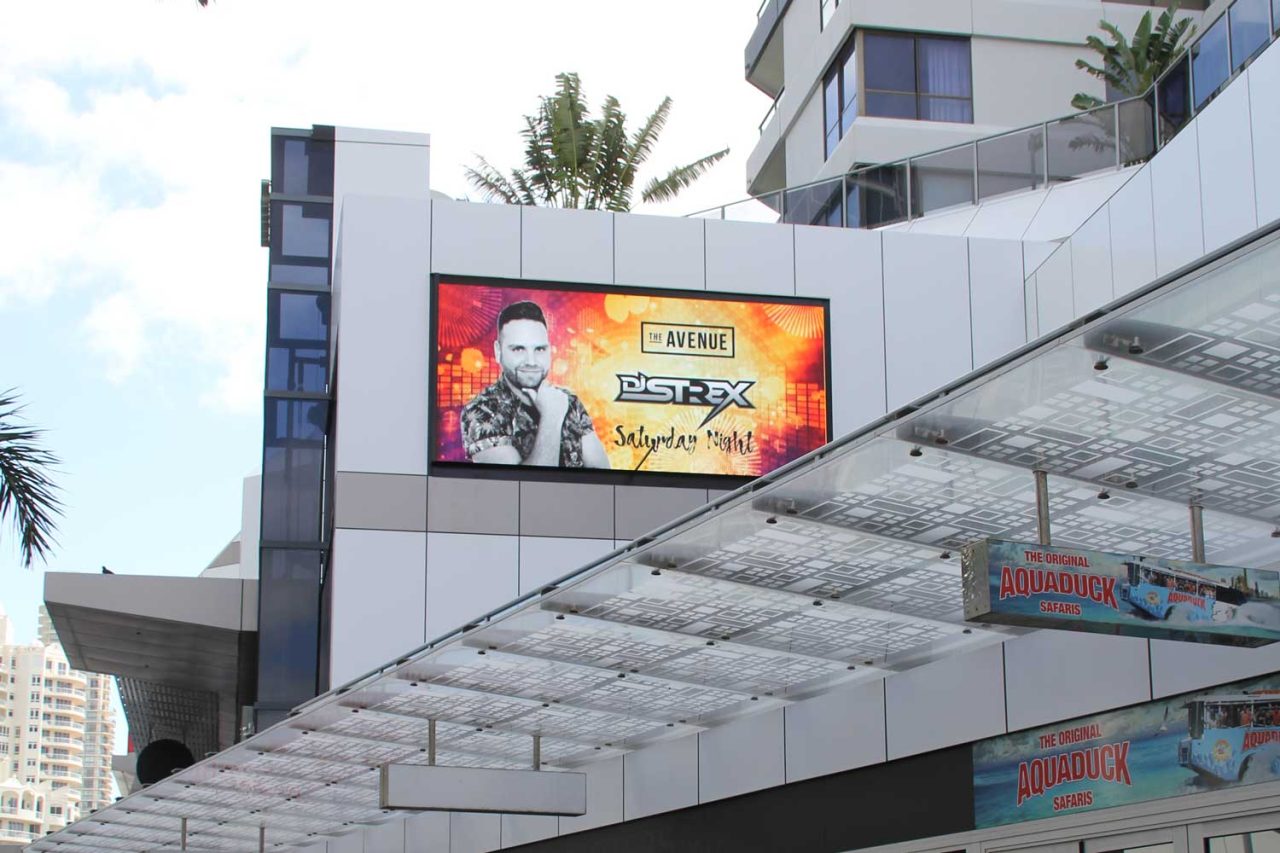 Restaurant advertising on The Mark's facade screen above the entrance canopy.
