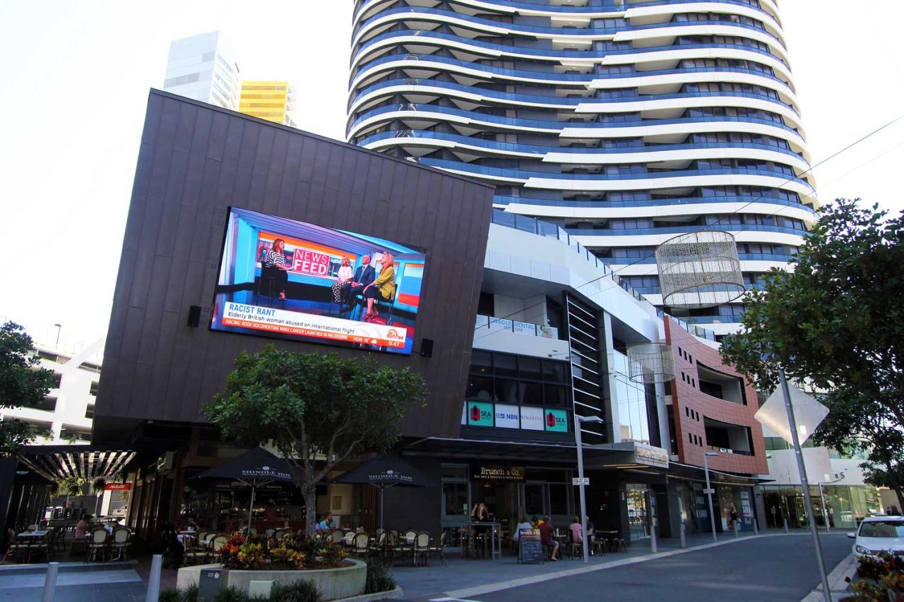 Colourful advertising on the large Oracle Boulevard screen.