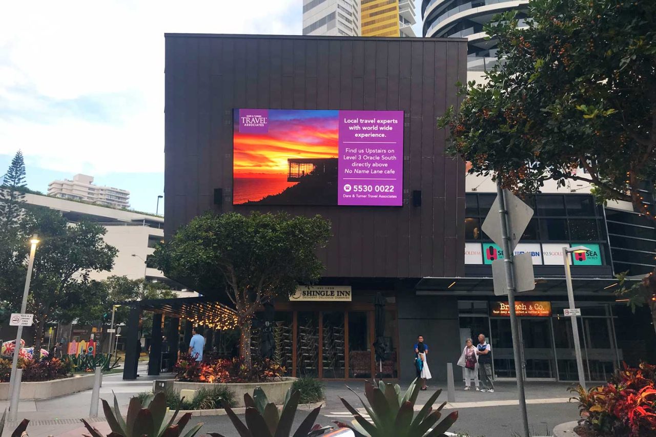 Promotional imagery and information on the Oracle Boulevard facade screen.