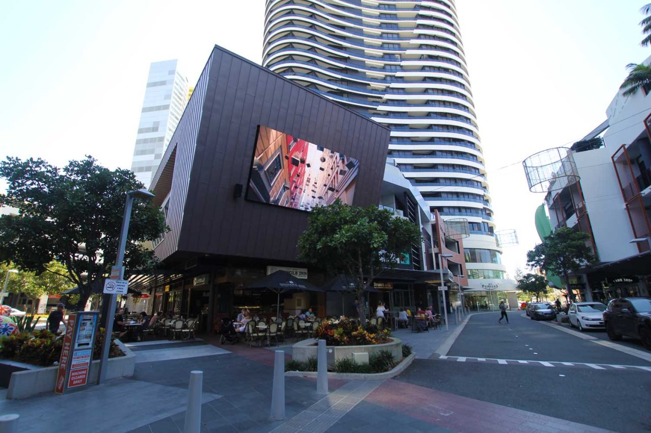Street view of the Oracle Boulevard digital screen beneath the residential tower.