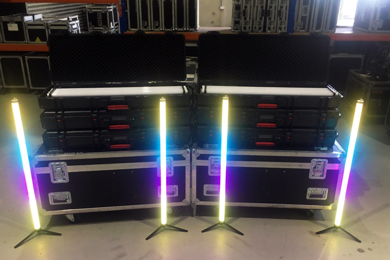 Four glowing Astera tubes beside flight cases at Elite Event Technology.