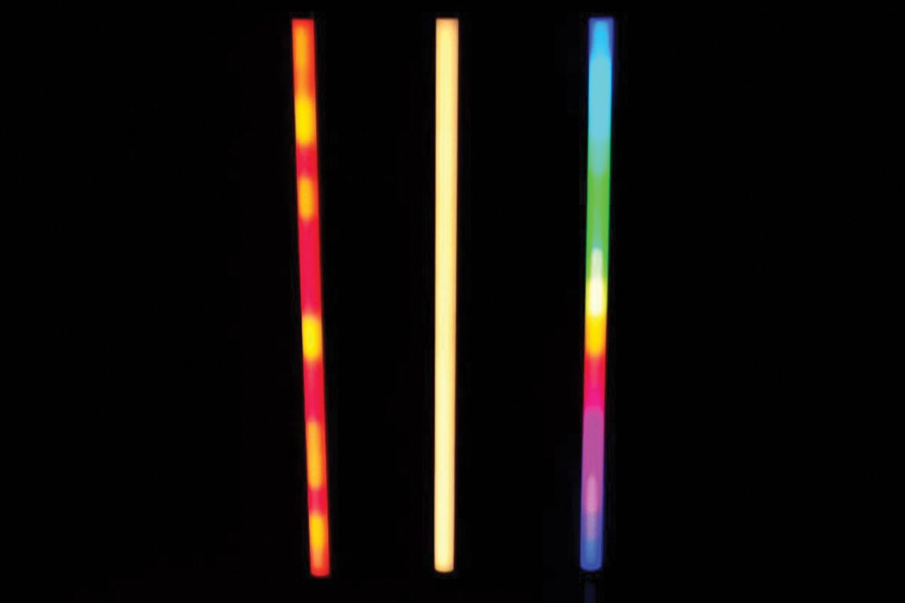 Three LED tubes displaying multicoloured segments against a black background.