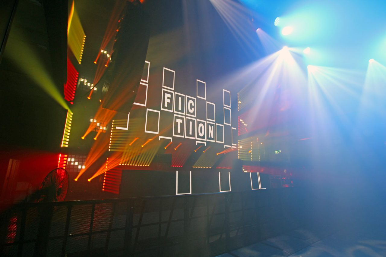 FCTN branding across the stage screen beneath coloured beams.