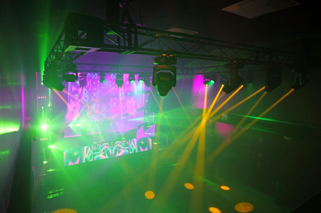 Green and yellow beams around the patterned video screen at FCTN in Canberra.