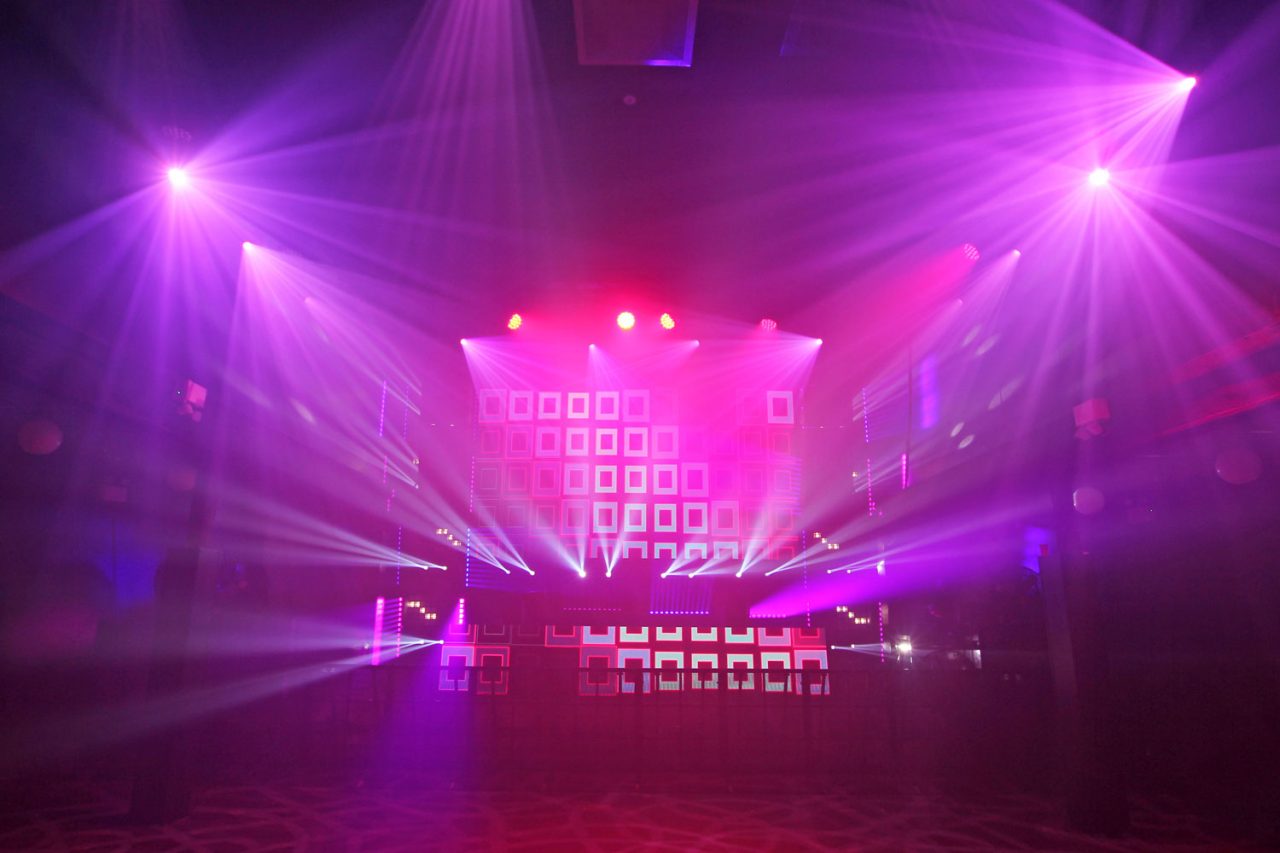 Pink and purple lighting around the geometric FCTN stage screen.