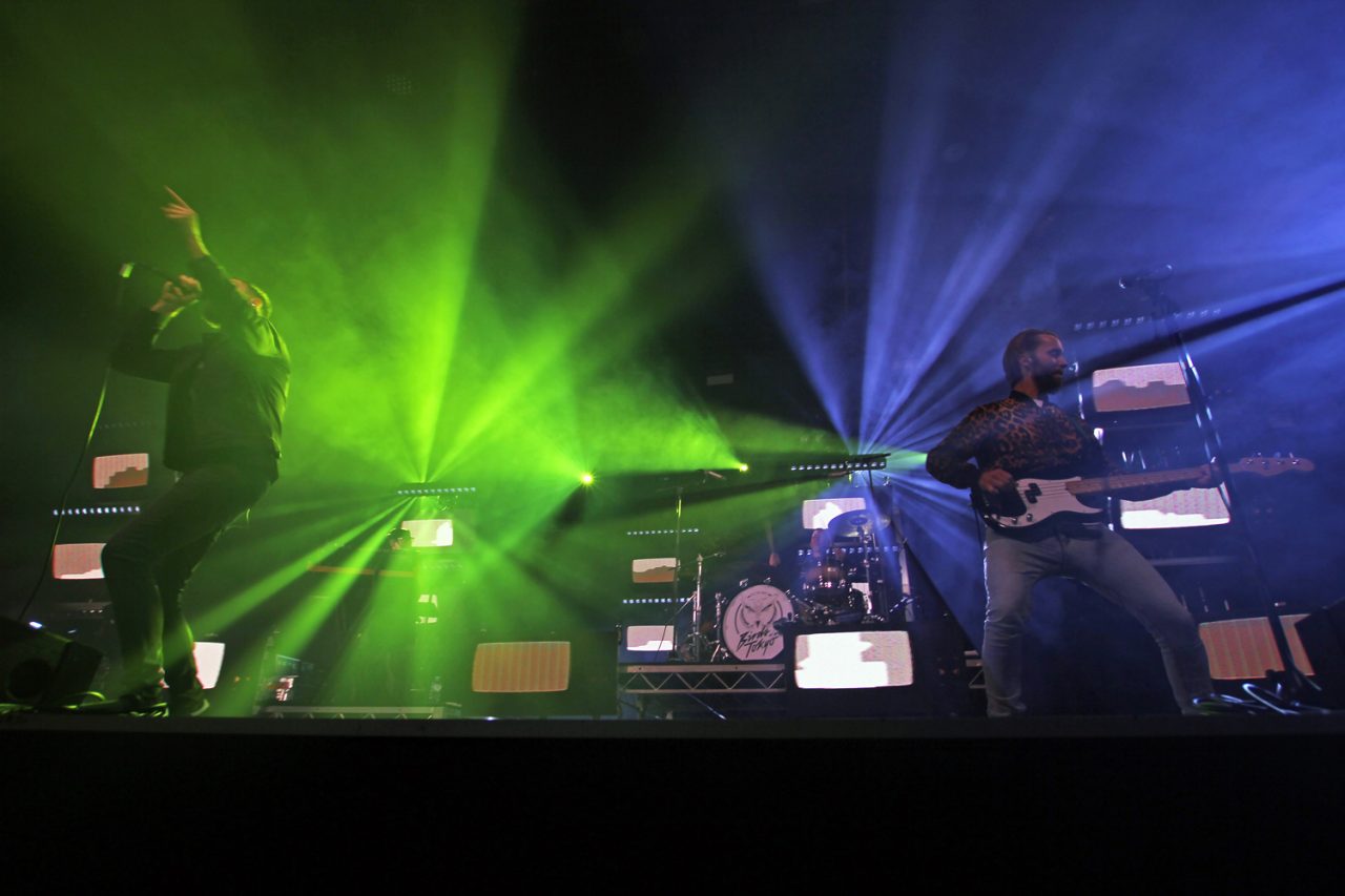 Birds of Tokyo stage with green and blue beams spreading behind the band.