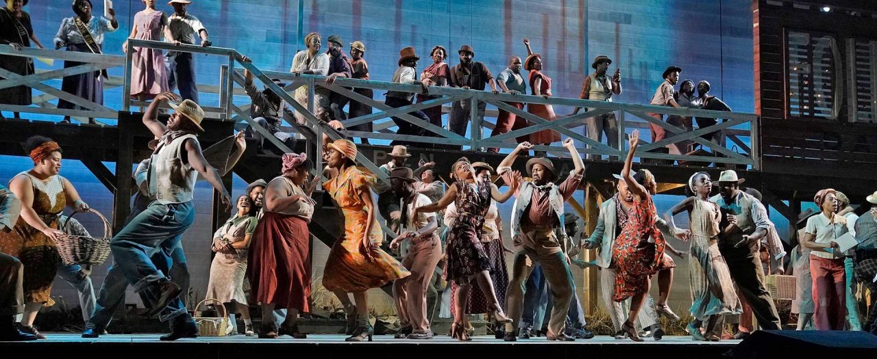 Large ensemble performing on a multilevel set in the Metropolitan Opera's Porgy and Bess.
