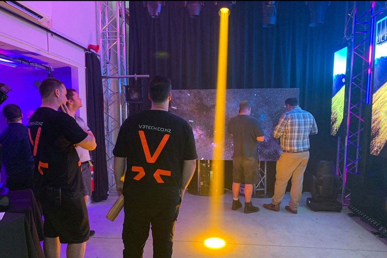 Guests watching a yellow beam demonstration in the Auckland showroom.