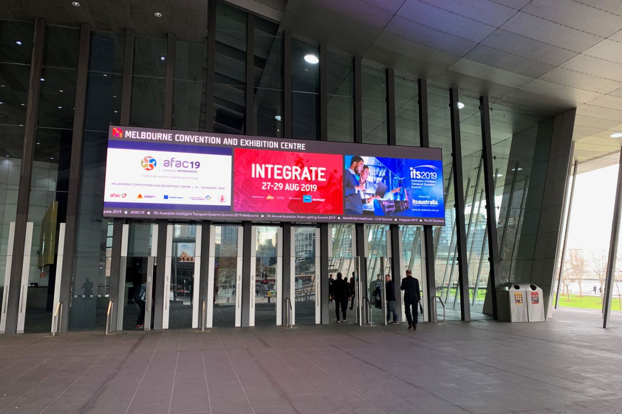 Event advertising on the wide screen above MCEC's Clarendon Street entrance.