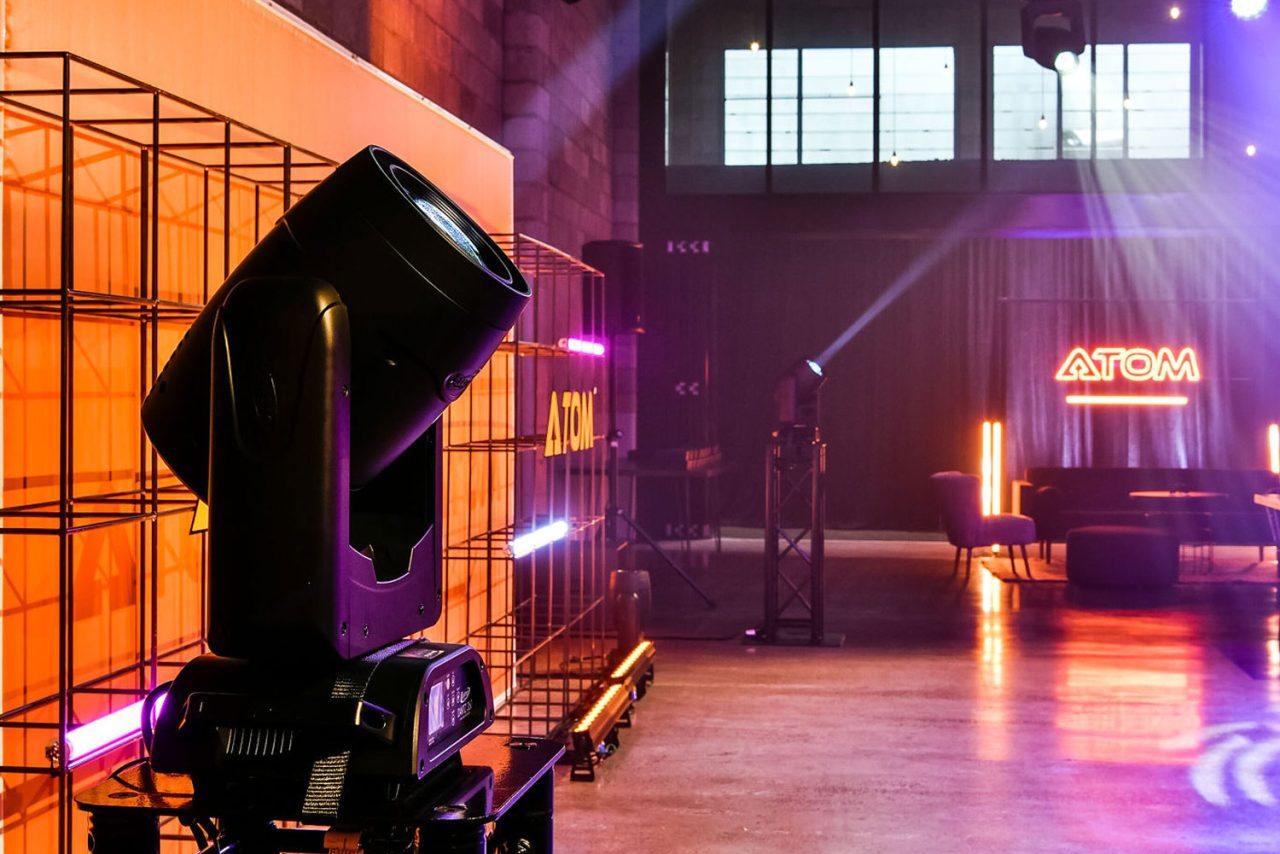 Elation Dartz fixture lighting a venue interior in pink and purple.