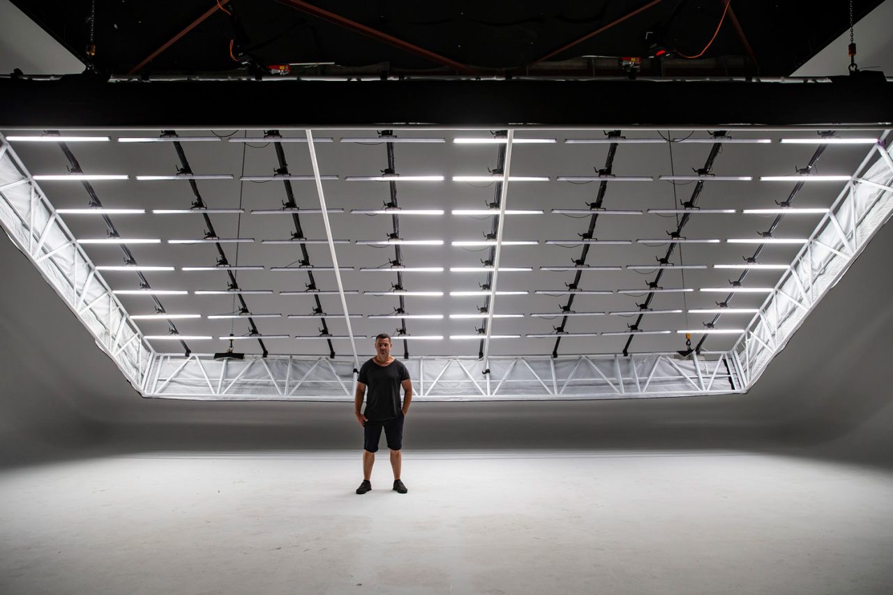 White tube-light grid suspended above the open floor at D1 Studios.