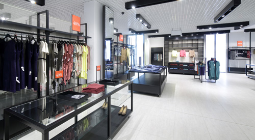 Clothing store with display racks and counters.