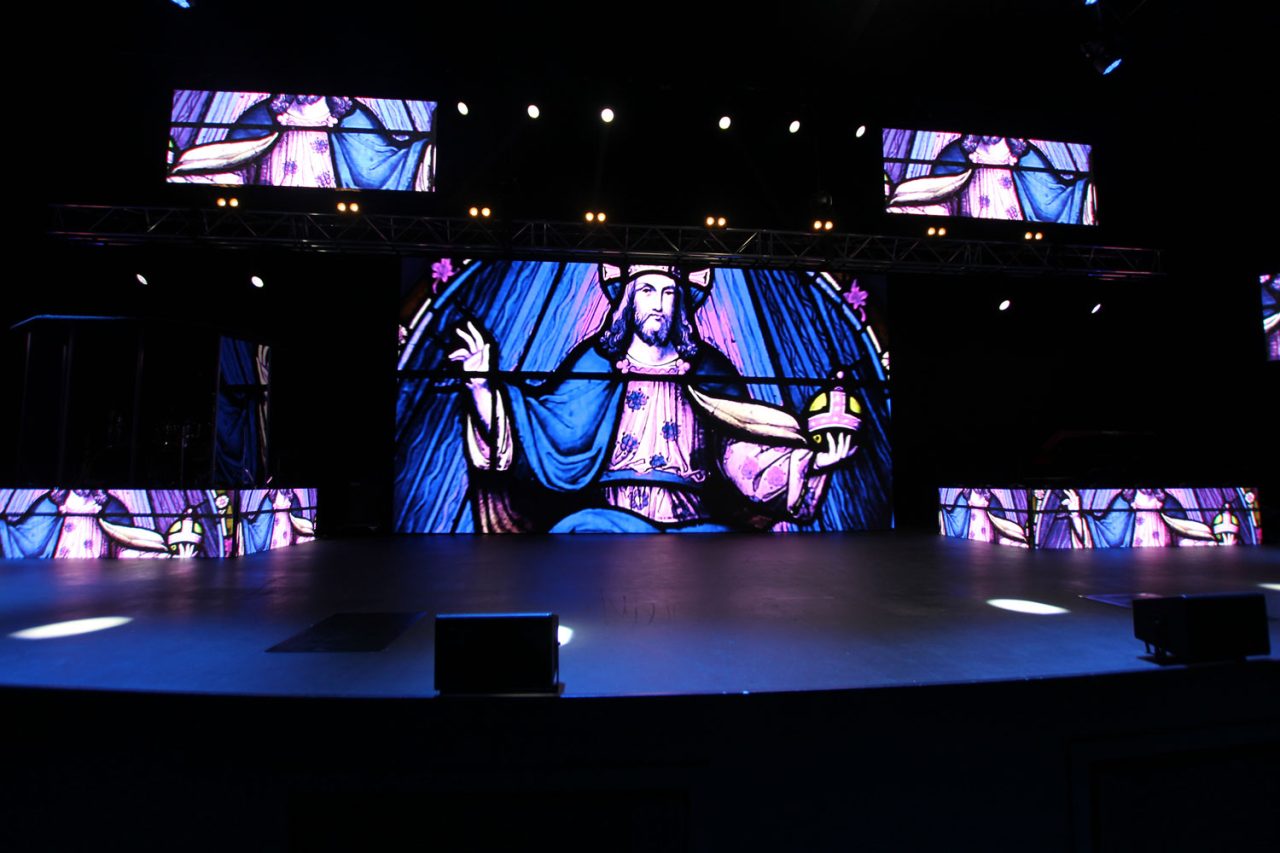 Front view of the Glow Church Gold Coast stage with coordinated imagery on the central and surrounding displays.