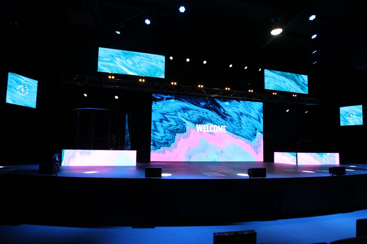 Stage displays at Glow Church Gold Coast showing coordinated blue and pink imagery.