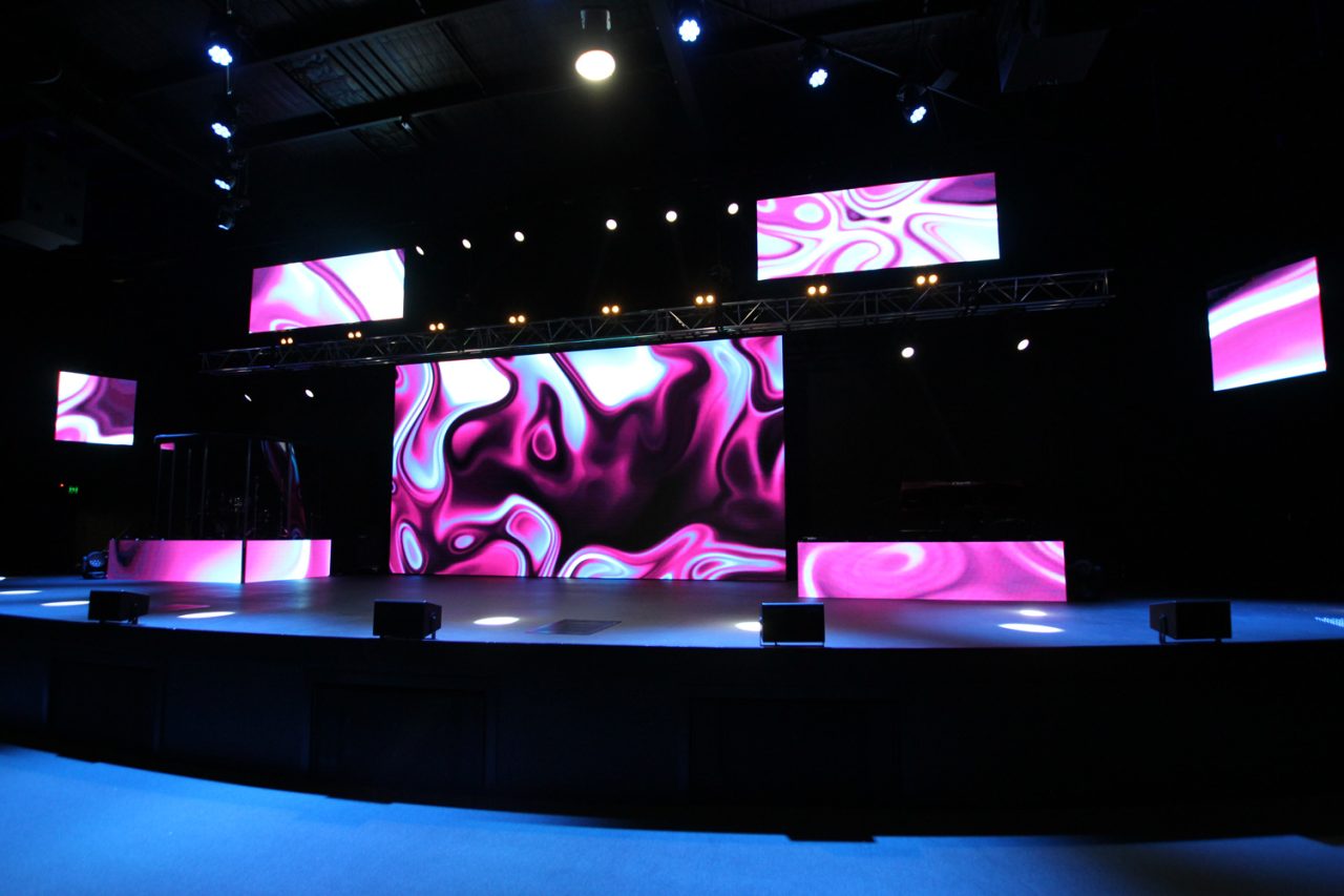 Stage displays at Glow Church Gold Coast filled with flowing pink and purple patterns.