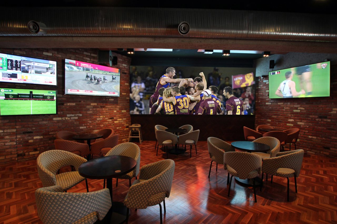 Large sports display above the seating at 1st on Wharf Tavern.