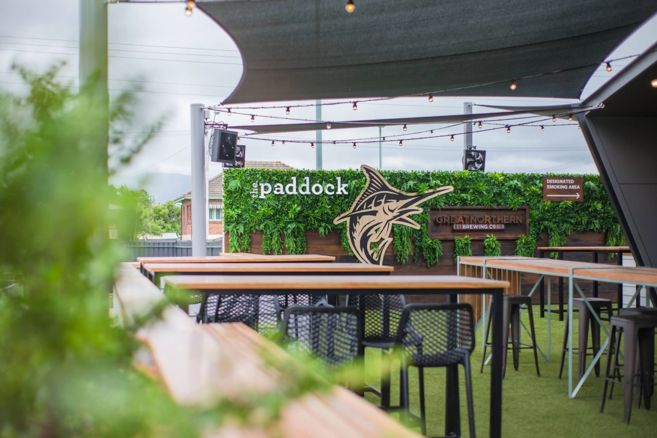 The Paddock alfresco area at Rockhampton Leagues Club, with a screen set into a green feature wall.