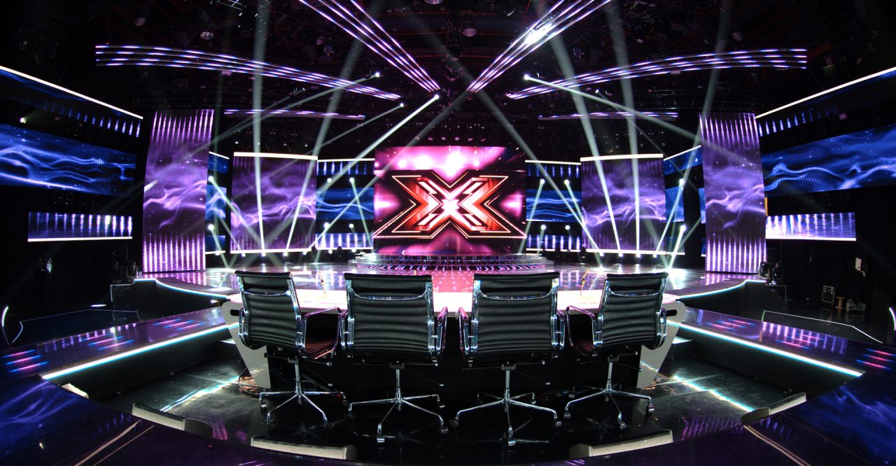 LED panels and white beams around the X Factor studio stage.