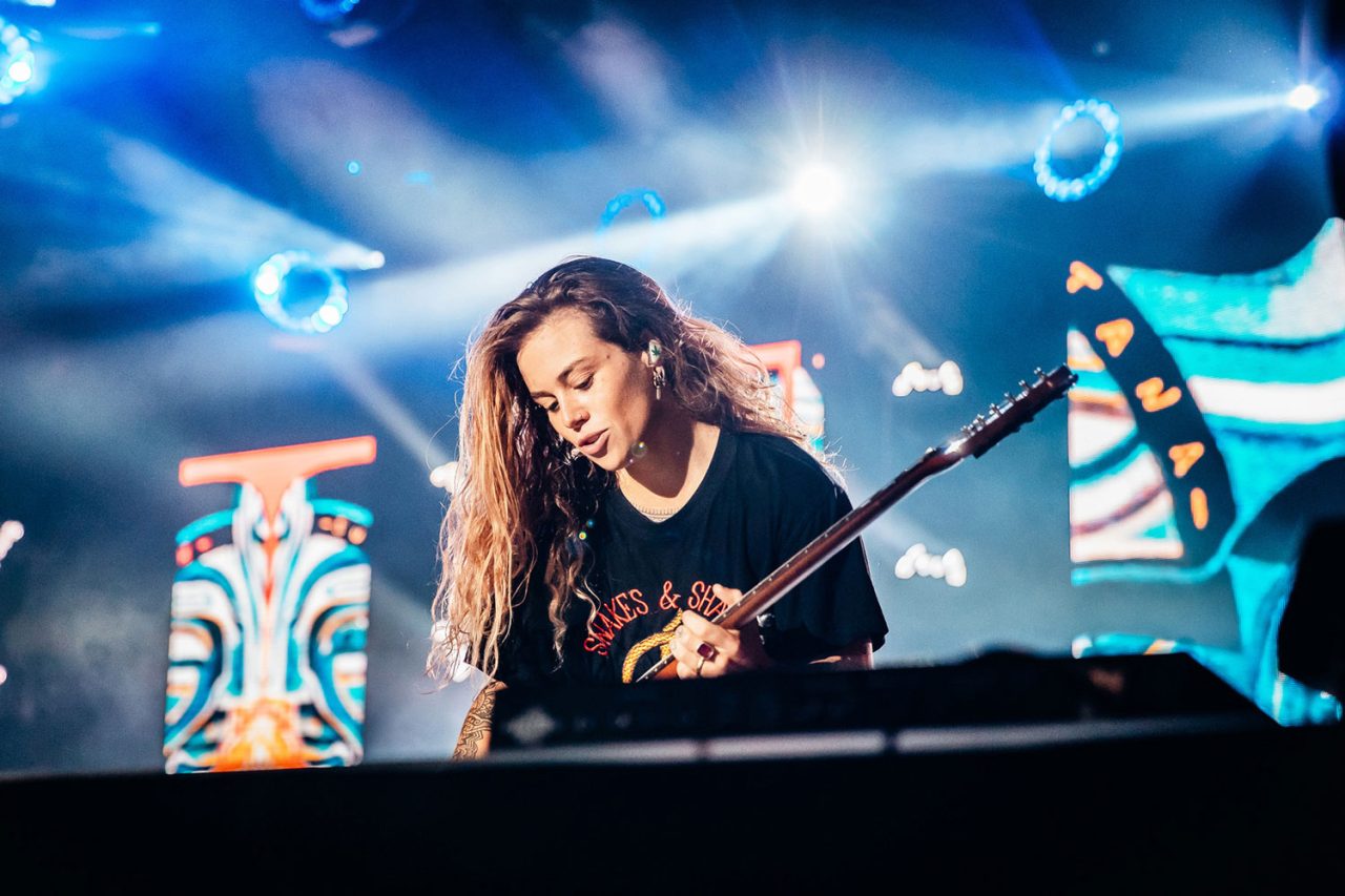 Close view of Tash Sultana performing on the illuminated Great Southern Nights stage.