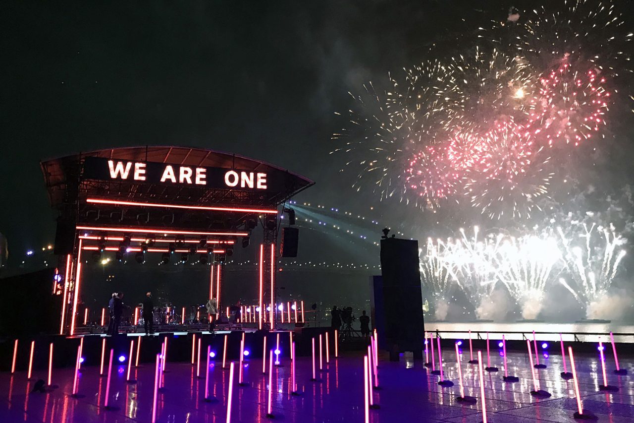 Fireworks and multicoloured light tubes surrounding the Field of Dreams stage.