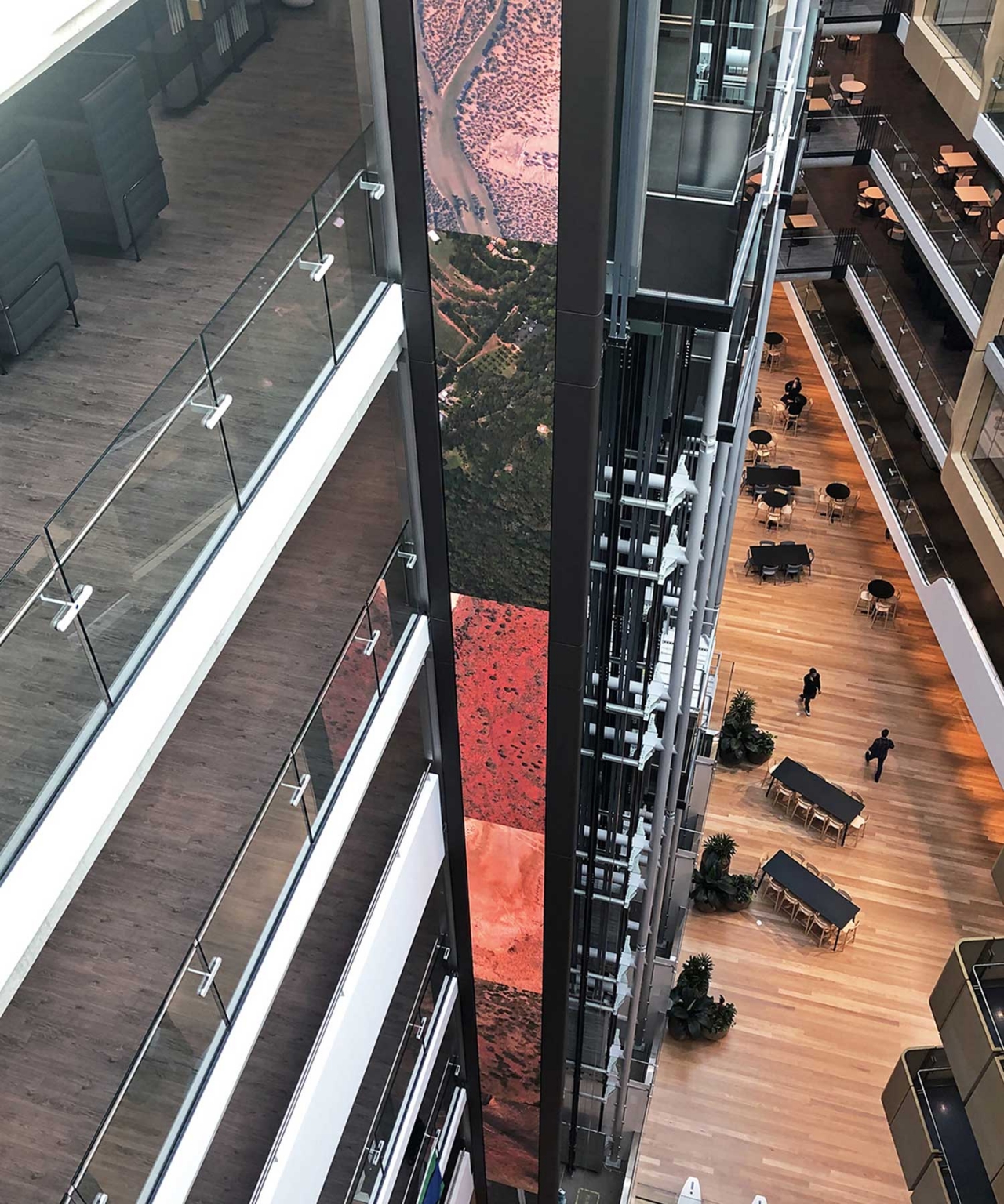 View down the LED column and glass lift shaft towards the headquarters seating area.