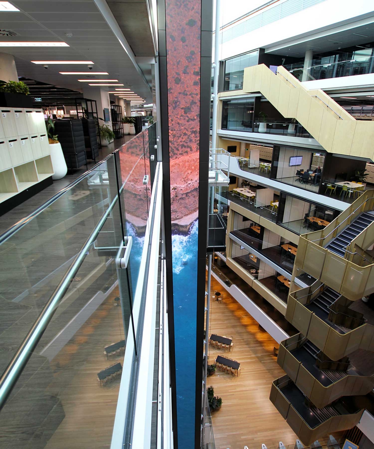 Upper-floor view of the digital LED column running through the Sydney headquarters atrium.