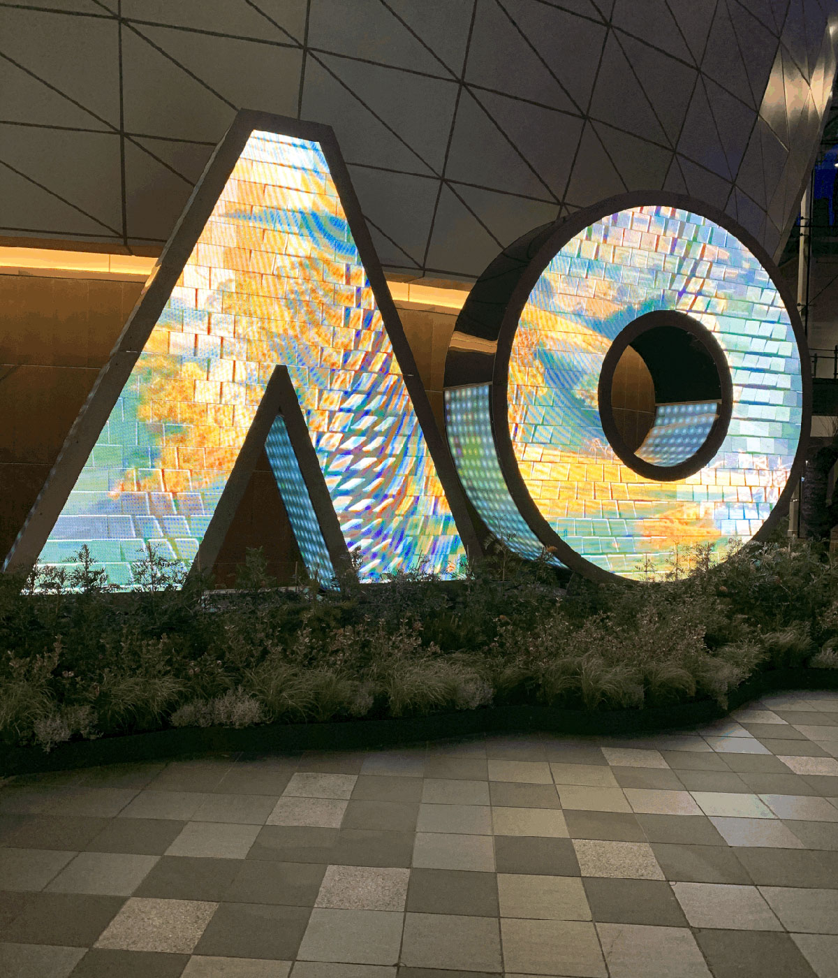 Illuminated AO letter sculpture at the Australian Open at night.