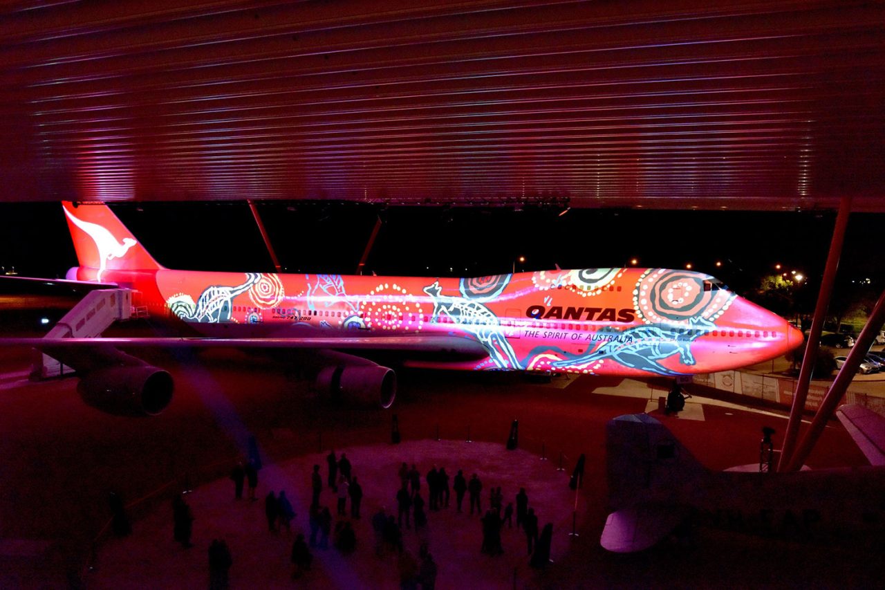 Colourful projection mapping across an aircraft at Qantas Founders Museum.