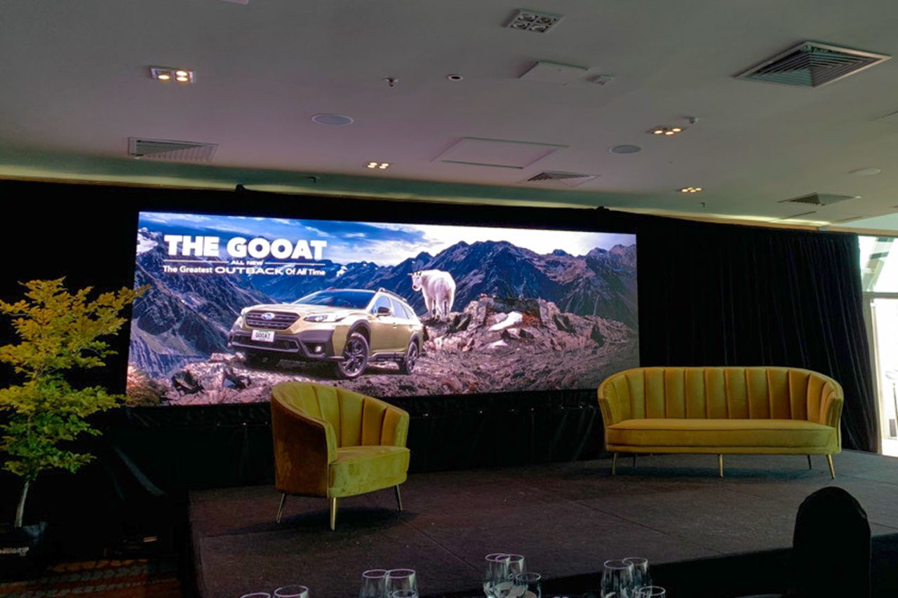 Subaru Outback presentation on the LED screen behind the event’s lounge seating.