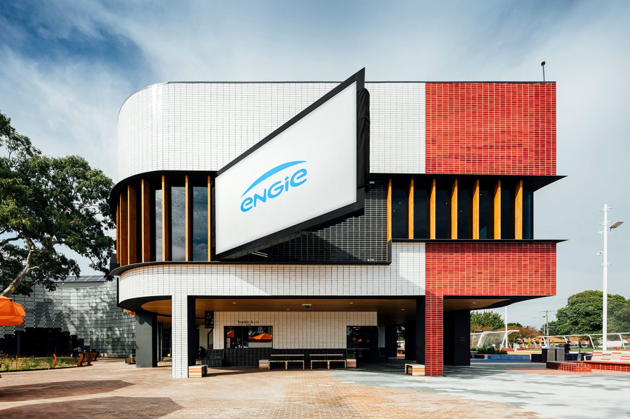 Springvale Urban Screen projecting out from the red and white building facade on its hinged mount.