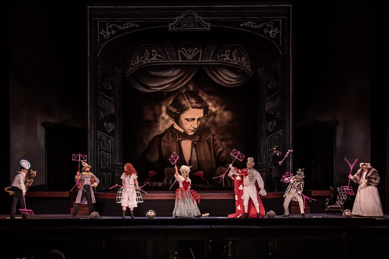 Performers across an ornate stage set at the Royal Opera House.