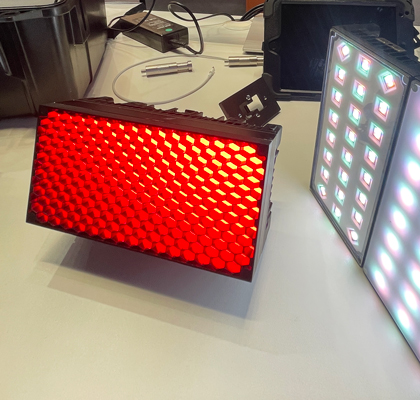 Two rectangular LED lighting panels demonstrating red and white output.