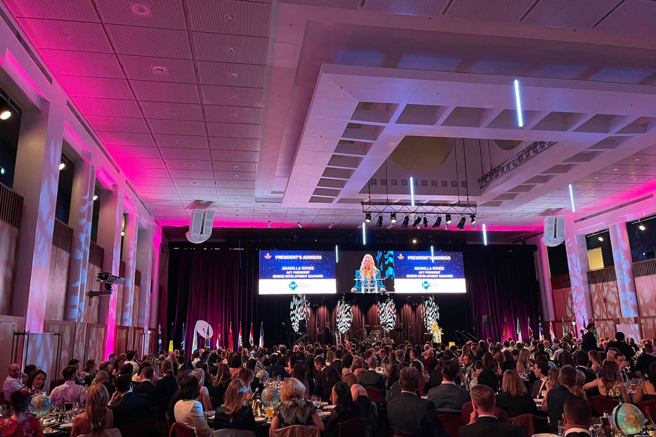 Guests beneath pink lighting and hanging light tubes at the Property Council ACT Awards.