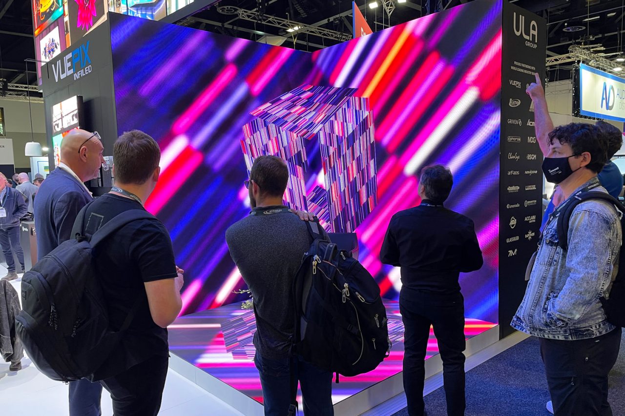 Visitors watch vivid graphics on a large video wall at Integrate 2022.
