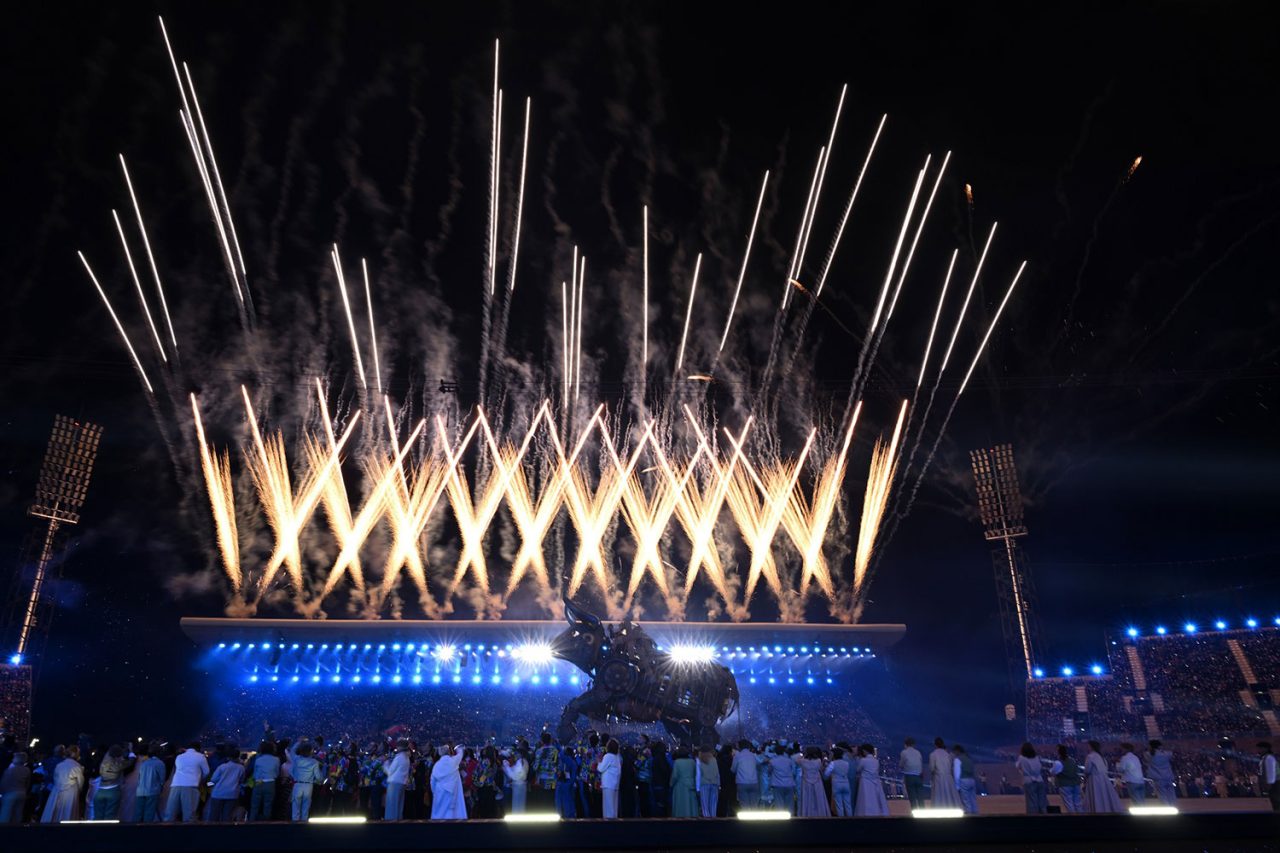 White fireworks above blue stage lighting at the Birmingham Commonwealth Games.