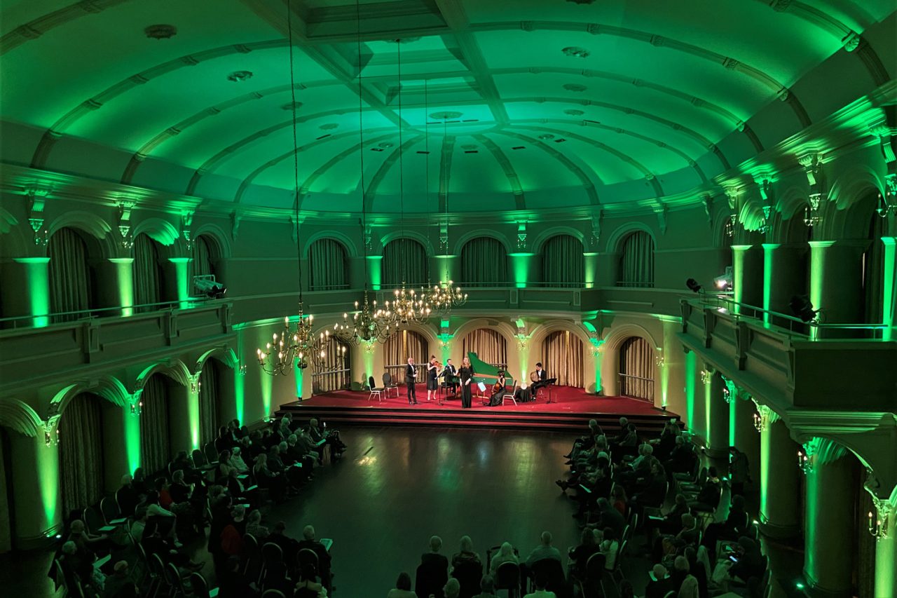 Green architectural lighting around the Government House Ballroom in Perth during Let Us Dance.