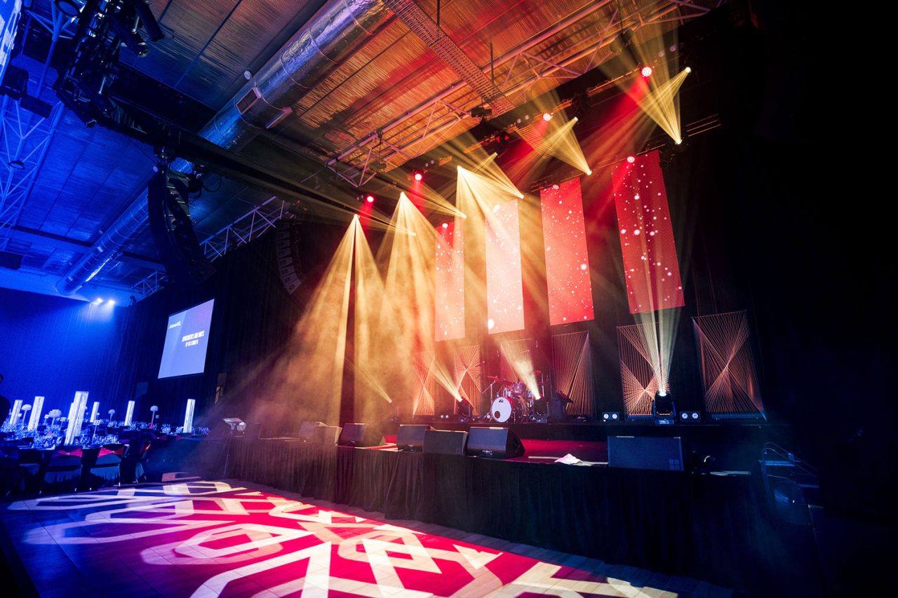 Amber beams across the stage and patterned dance floor at the Master Builders awards.