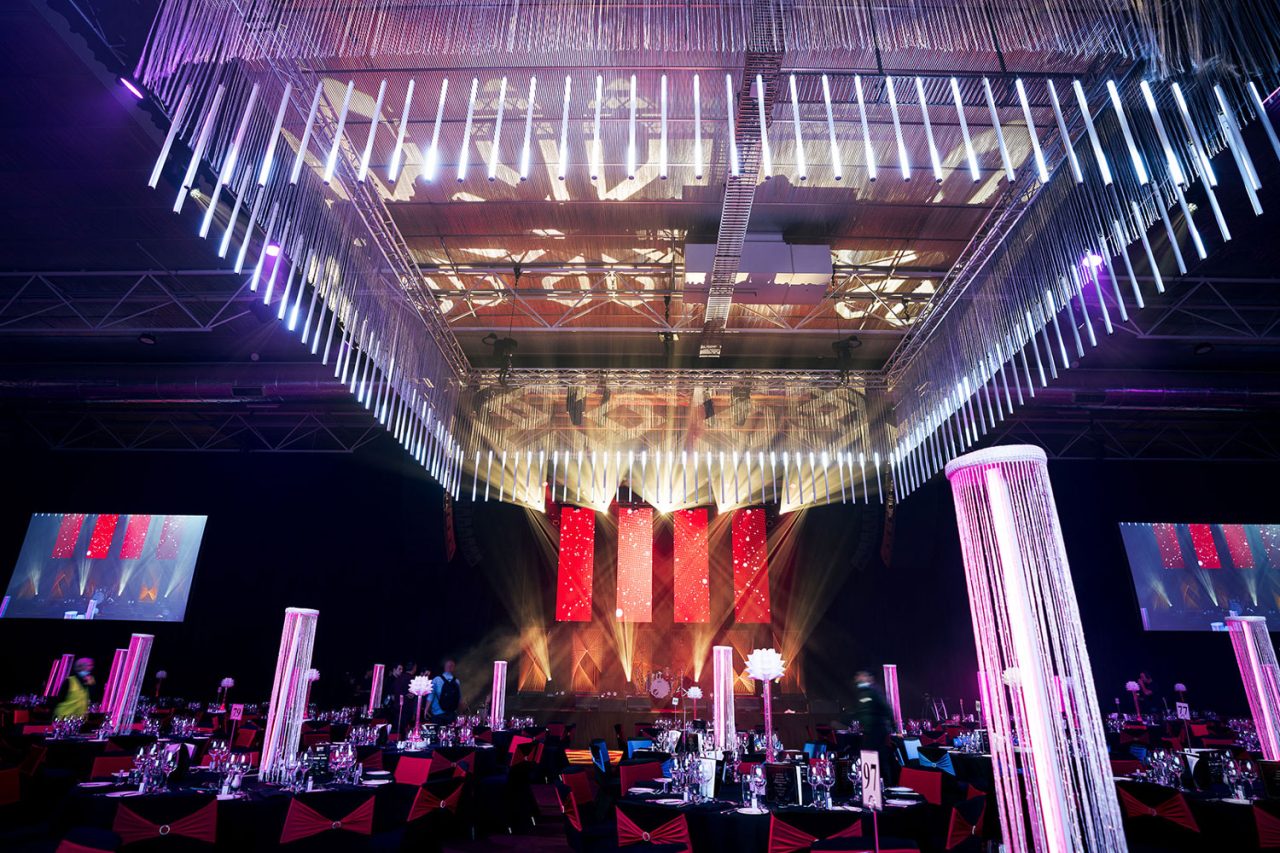 Suspended light tubes above banquet tables and the Master Builders awards stage.
