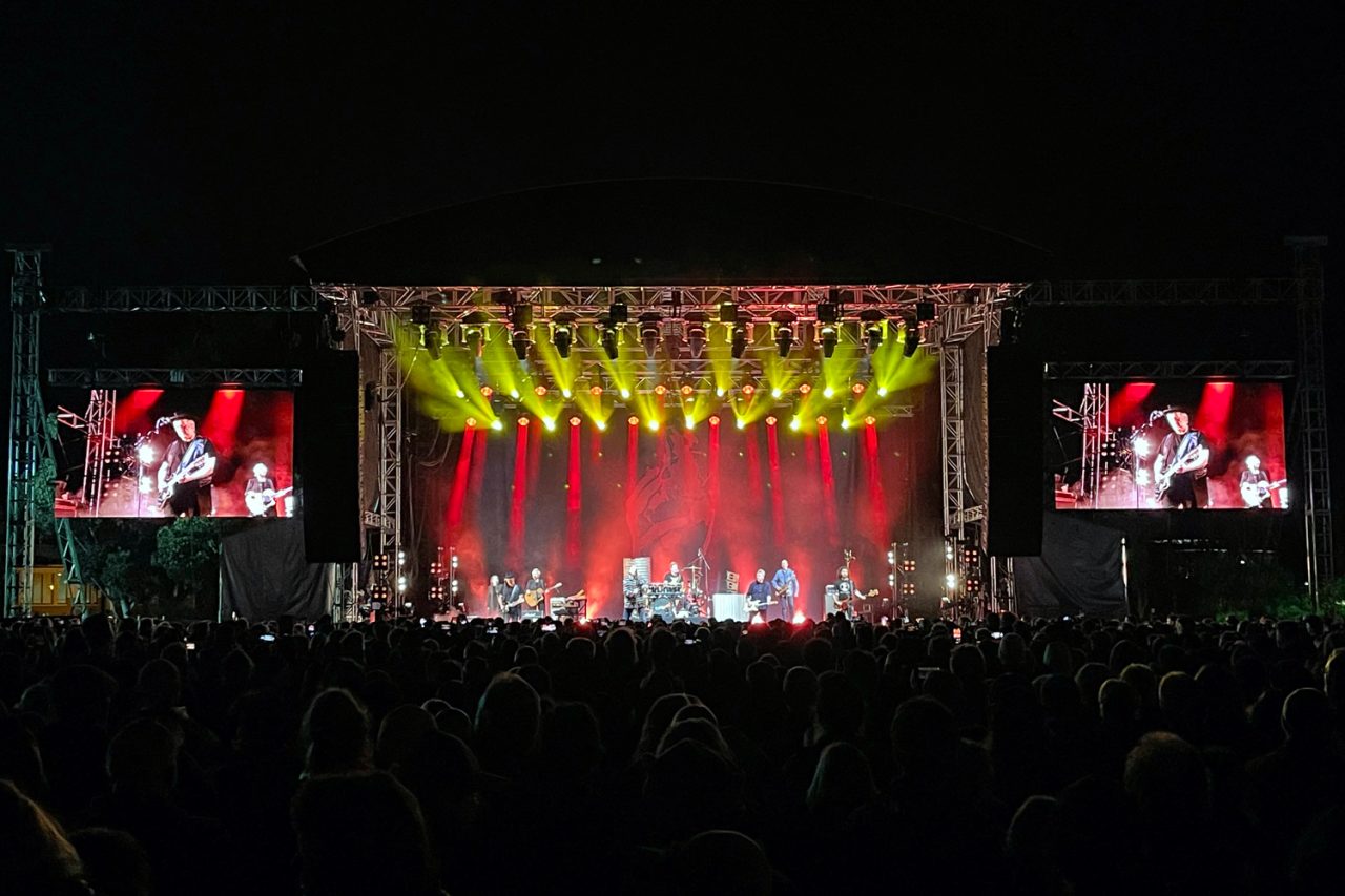 Gold stage beams and live side screens at Midnight Oil's Canberra show.