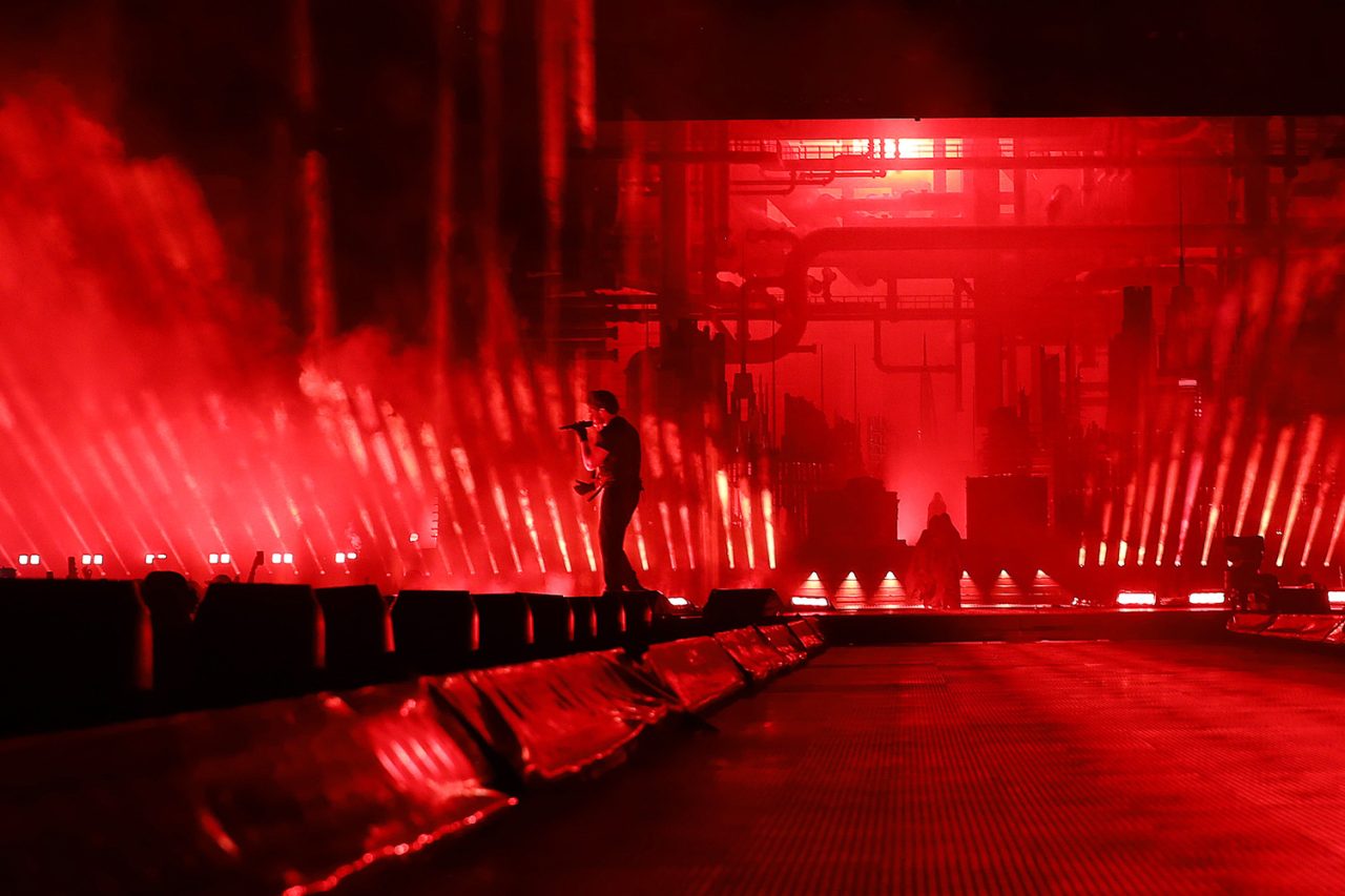 A performer silhouetted on a red-lit runway during the After Hours til Dawn tour.