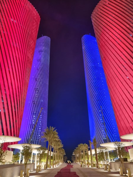 Red and blue lighting on the Lusail Plaza Towers viewed from below.